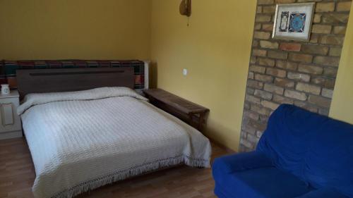 a bedroom with a bed and a blue chair at Tik Saviem in Palanga