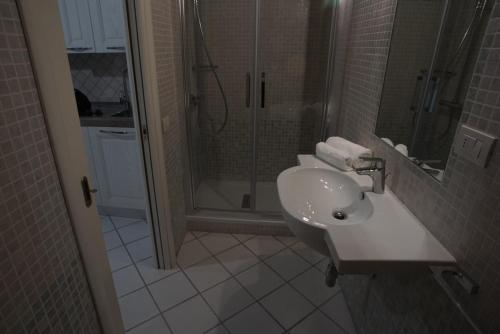 a bathroom with a sink and a shower at L'Orchidea Bianca in Cagliari