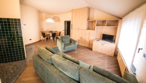 a living room with a couch and a dining room at Appartamenti Pirovano Bormio in Bormio