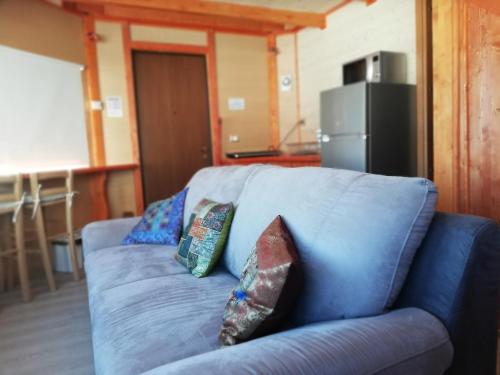 a blue couch in a room with pillows on it at DalaiLama Village in Antey-Saint-André