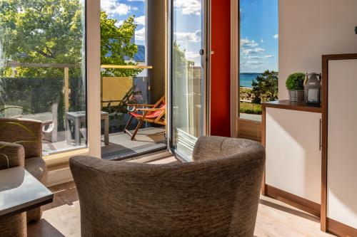 a living room with a view of the ocean at Seaside-Strandhotel in Timmendorfer Strand