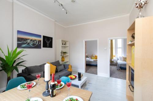 a living room with a couch and a table at homely - Central London King’s Cross Apartments in London