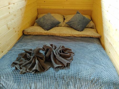 a bed in a room with a blanket on it at Apartamenty przy Jeziorze Żywieckim z widokiem na Skrzyczne in Żywiec