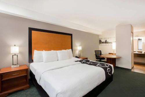 a hotel room with a large bed and a desk at La Quinta Inn by Wyndham Everett in Everett
