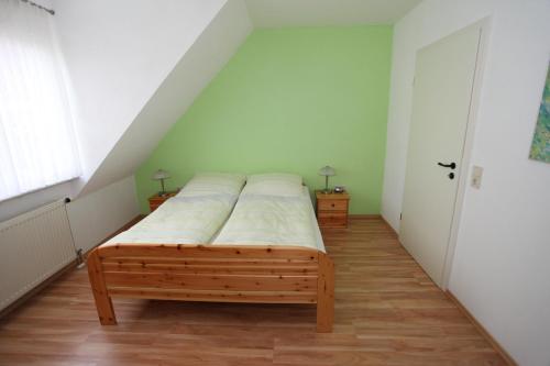 a bedroom with a bed with white sheets on it at Gästehaus Becker in Wachenheim an der Weinstraße