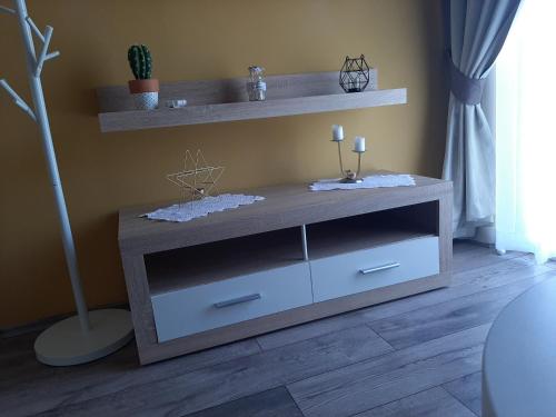 een woonkamer met een houten plank en een tafel bij Rooms Neda in Rab