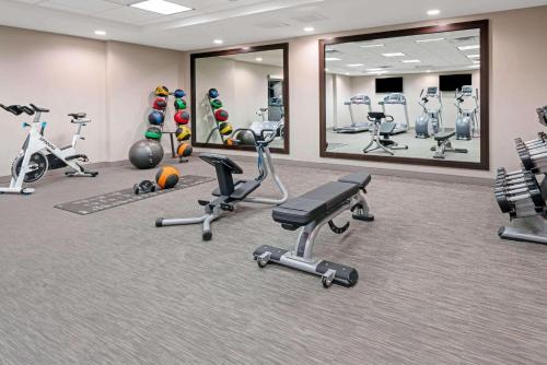 a fitness room with exercise equipment and mirrors at La Quinta by Wyndham Orem University Pwy Provo in Orem