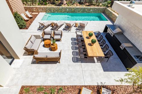 a patio with a table and chairs and a pool at Villa Torrenova 36 in Magaluf