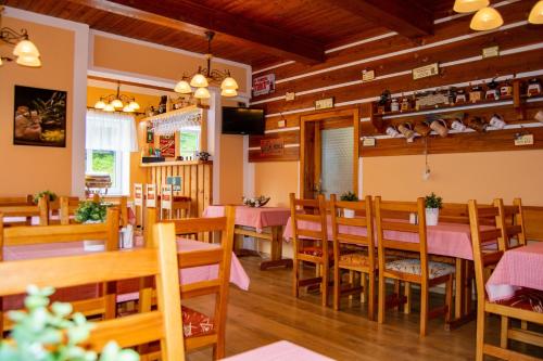 a restaurant with wooden floors and tables and chairs at Horská chata Milíře in Pec pod Sněžkou