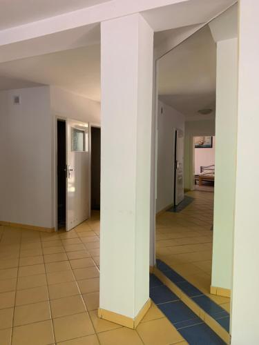 a hallway with columns in a building at Yacht Club Apartamenty in Radzyń