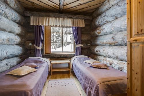 Una cama o camas en una habitación de Rukan Salonki Chalets