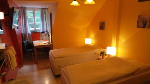 a hotel room with two beds and a desk and a window at Gasthof Bären Aarburg last Check in 2100 pm in Aarburg