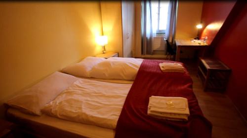 a hotel room with two beds with towels on them at Gasthof Bären Aarburg last Check in 2100 pm in Aarburg