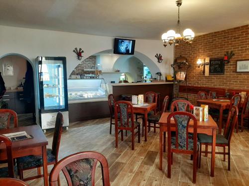ベチョフ・ナト・テプロウにあるPenzion - Restaurant U Zámkuの木製テーブルと椅子付きのダイニングルーム
