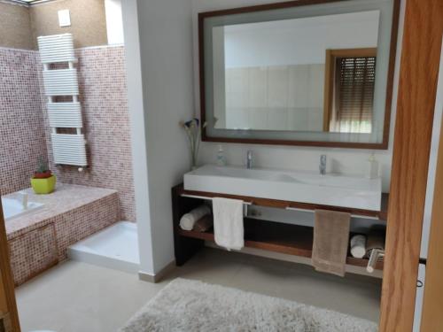 マングァルデにあるMourilhe Guest Houseのバスルーム(大きな鏡、シンク付)