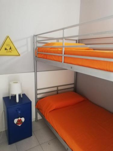 two bunk beds in a room with a sign on the wall at Calella Flats & More in Calella