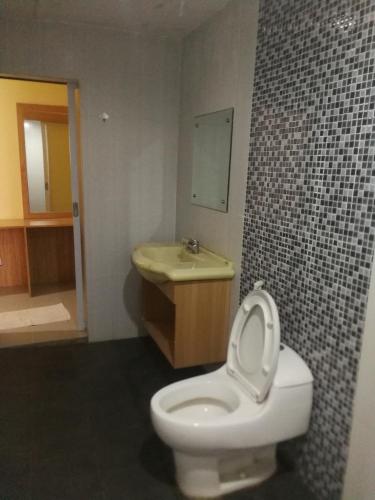 a bathroom with a toilet and a sink at Hotel Mayang Sari 1 in Jambi