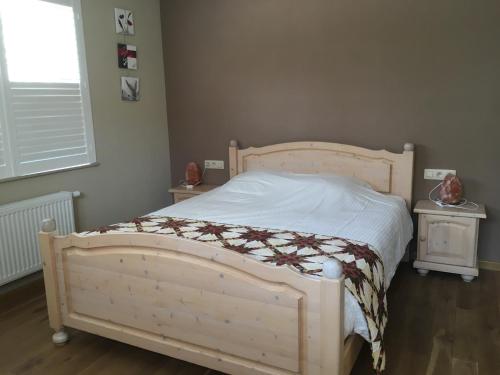 a bedroom with a bed and two night stands at B&B Wisteria in Herne