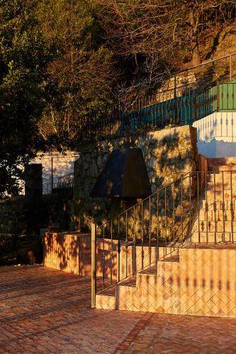 a bell hanging from a fence next to a staircase at Boutique Hotel Mendi Argia in Donostia-San Sebastián