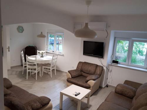 a living room with a couch and a table at Apartment Nona in Šmrika