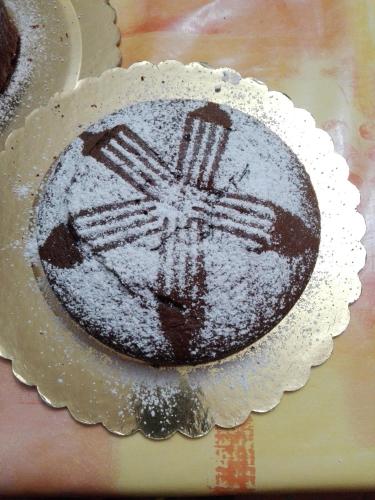 a chocolate cake with powdered sugar on top of it at Segesta Antichi Sapori in Calatafimi