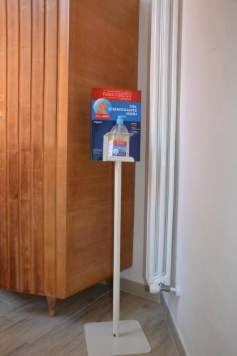 a gallon of milk on a stand next to a door at Colosseum relax family apartament in Rome
