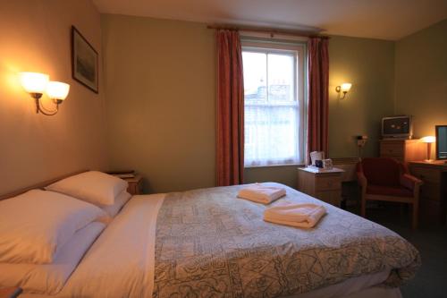 Ένα ή περισσότερα κρεβάτια σε δωμάτιο στο Cumberland Inn