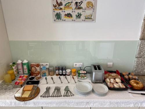 a kitchen counter with plates and other items on it at Casa de Ribadouro in Baião