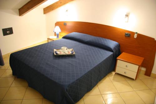 a bedroom with a blue bed with a tray on it at Residenza D'epoca Tamara in Castellabate