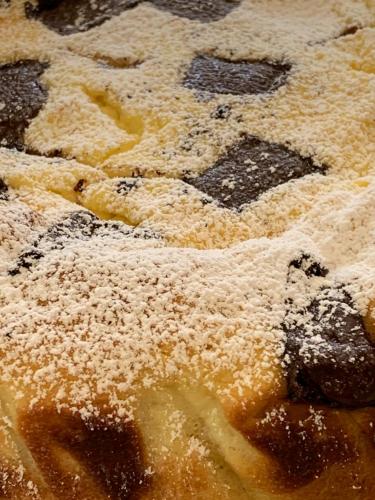 a pastry with powdered sugar on top of it at B&B Beauty House in Cesena