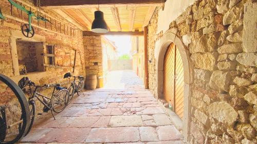 an alley with bikes parked in a stone building at LANDHOTEL 1707 by Landgasthof Zickler in Gleisweiler