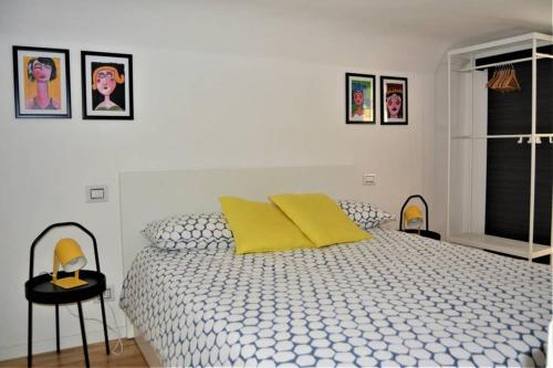 a bedroom with a bed with yellow pillows and a window at Dock78 - MiniLoft in Catania Center in Catania