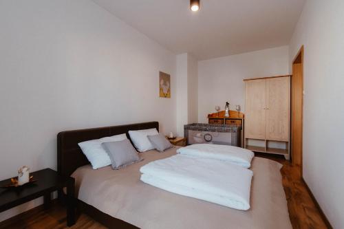 a bedroom with a bed with two pillows at Apartament Molo in Giżycko