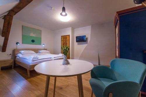 a bedroom with a bed and a table and chairs at Alt Straninger in Český Krumlov