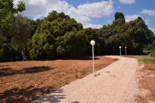 two street lights on the side of a dirt road at Masseria Poli Country House in Conversano