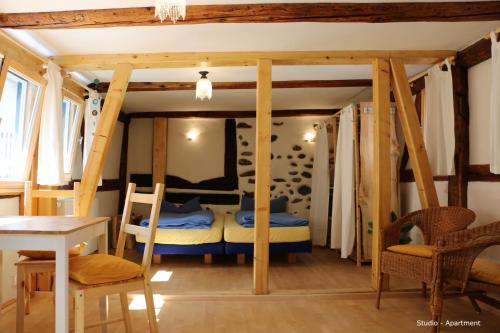 a room with a bed and a table and chairs at Bio-Ferienwohnung Ellensohn in Lindau