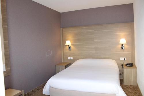 מיטה או מיטות בחדר ב-Hotel Des Tilleuls