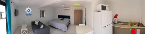 a bedroom with a bed and a sink in a room at Varadero Marina Airport Guests Rooms in Oranjestad