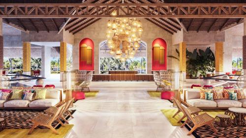 a lobby with couches and a chandelier at Tropical Deluxe Princess - All Inclusive in Punta Cana