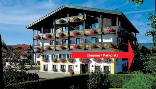 a building with flowers on the side of it at Tirolerhof in Sankt Georgen im Attergau
