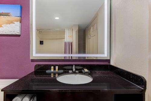 a bathroom with a sink and a mirror at La Quinta Inn by Wyndham West Long Branch NJ Shore Area in West Long Branch