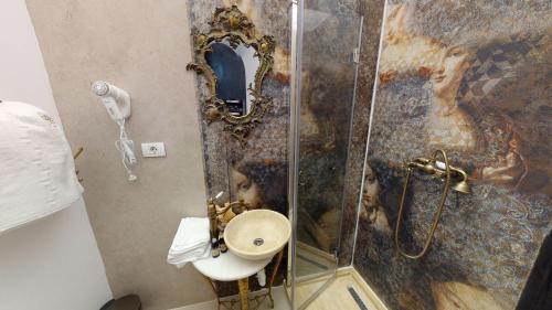 a bathroom with a shower with a sink and a mirror at Conacul Coroanei Luxury Boutique Hotel in Bucharest