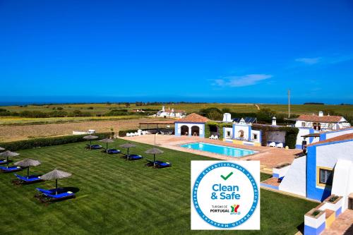 a resort with a pool and a sign for a spa at Herdade Do Touril in Zambujeira do Mar