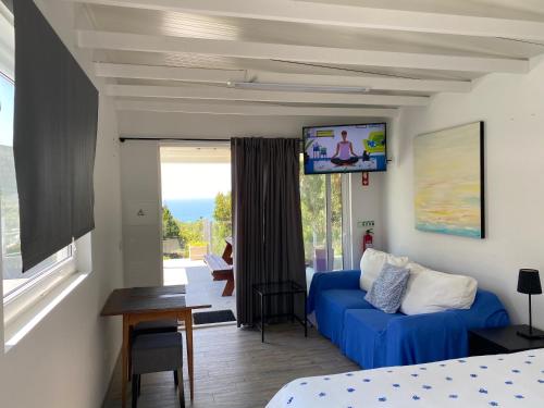 a living room with a couch and a tv at Silver Coast Vacation - Your Unique Inn in Lourinhã