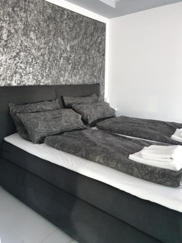 a black and white bedroom with a black bed at Andromachi Apartments in Jembke