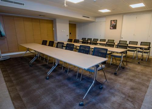 a classroom with rows of tables and chairs at Novotel Mohammedia in Mohammedia