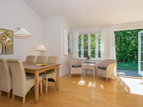 a dining room with a wooden table and chairs at 8 person holiday home in Aabenraa-By Traum in Aabenraa