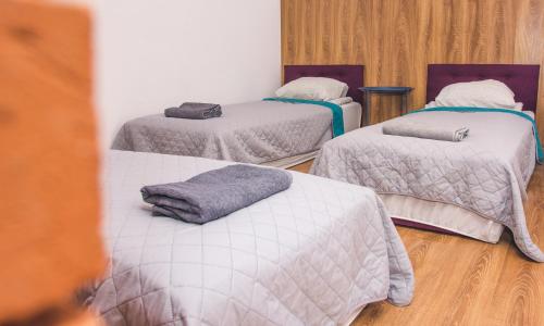 a room with three beds with white sheets on them at Apartamenty w Świeciu CS17 in Świecie