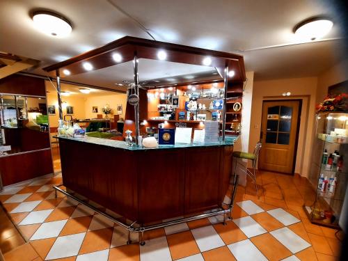a kitchen with a bar in the middle of a room at Vila Viktória in Rajecké Teplice
