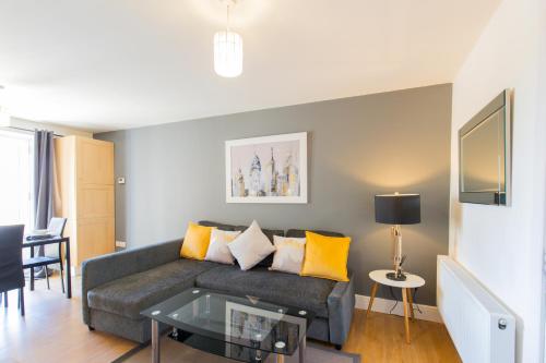 a living room with a couch and a table at Velvet 1-bedroom apartment, Clockhouse, Hoddesdon in Hoddesdon